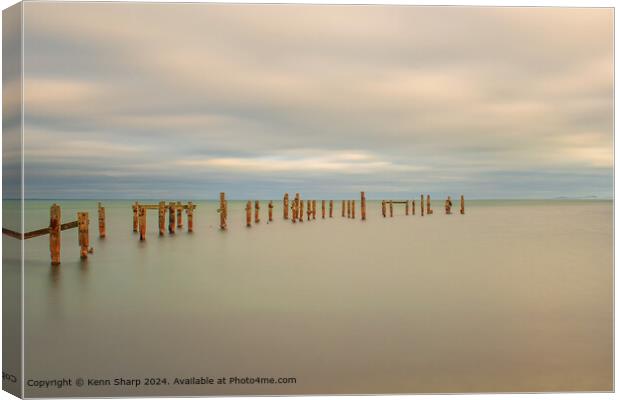 A fine art slow shutter tranquil seascape with old weathered wooden pier posts Canvas Print by Kenn Sharp