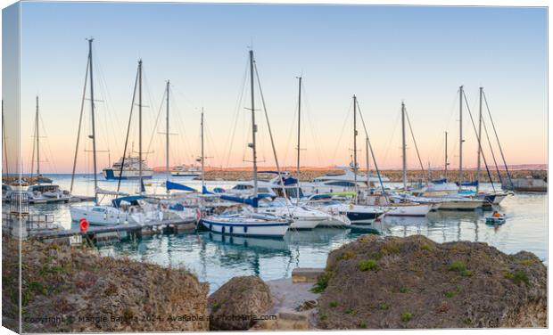 Sunset with Boats and Ferries at Mgarr Harbour, Gozo, Malta. Canvas Print by Maggie Bajada