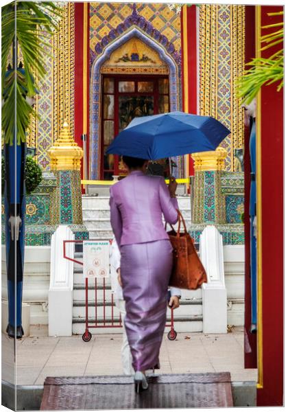 Thai Woman with Umbrella at Wat Ratchabophit Canvas Print by Kevin Hellon