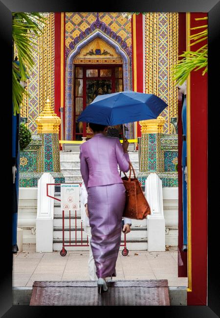 Thai Woman with Umbrella at Wat Ratchabophit Framed Print by Kevin Hellon