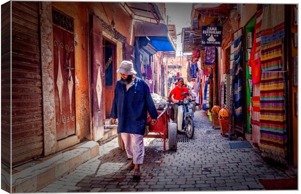 Marrakesh Man Pulling Cart Canvas Print by Kevin Hellon