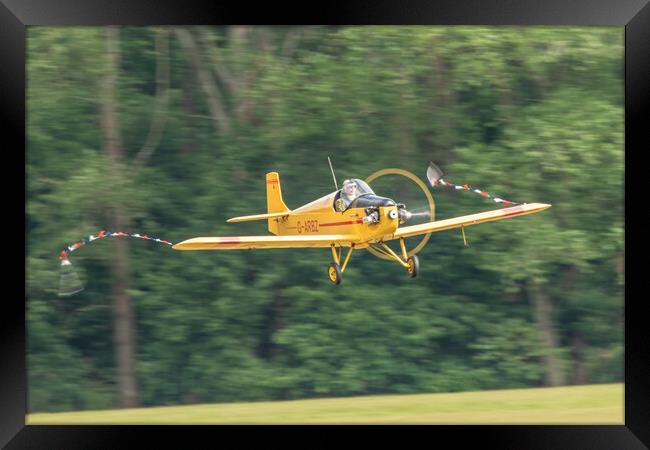 Turbulent Flying Aircraft in Forest Framed Print by J Biggadike