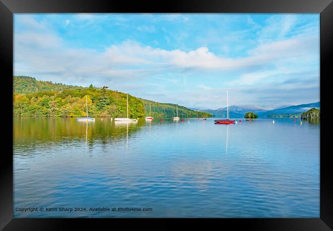 A beautiful calm view of the colourful boats on Lake Ullswater Framed Print by Kenn Sharp