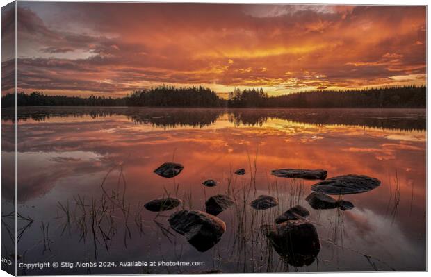 shoreline with pebbles at sunrise over a calm lake  Canvas Print by Stig Alenäs