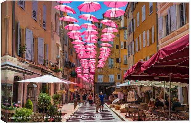 Pink umbrellas in old town Grasse, French Riviera Canvas Print by Angus McComiskey