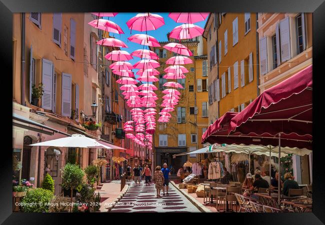 Pink umbrellas in old town Grasse, French Riviera Framed Print by Angus McComiskey