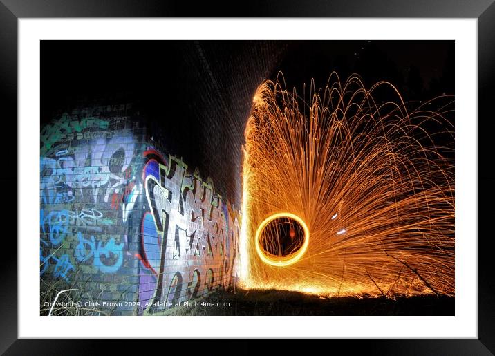 Graffiti illuminated by fire Framed Mounted Print by Chris Brown