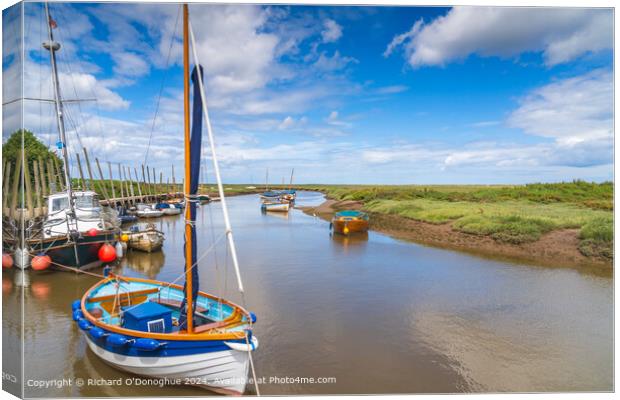 Serene scene with boats in Blakeney harbour Canvas Print by Richard O'Donoghue