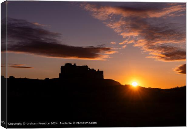 Bamburgh Castle Sunset Silhouette at Sunset Canvas Print by Graham Prentice