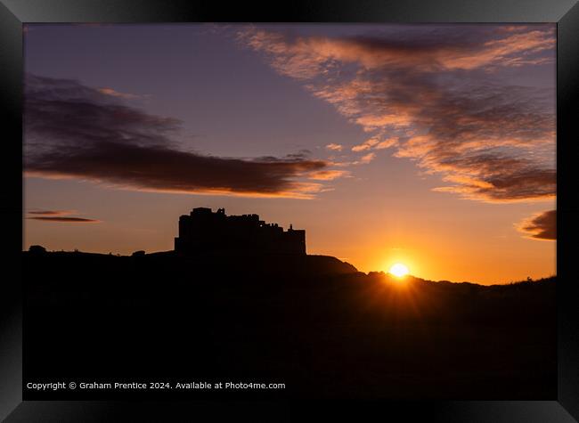 Bamburgh Castle Sunset Silhouette at Sunset Framed Print by Graham Prentice