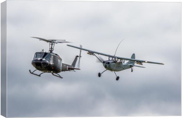 Cessna O-1 Bird Dog and Bell UH-1 Huey Helicopter Canvas Print by J Biggadike