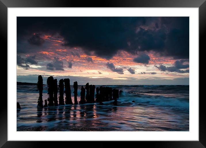 Ancient posts in glossy water Framed Mounted Print by Izzy Standbridge