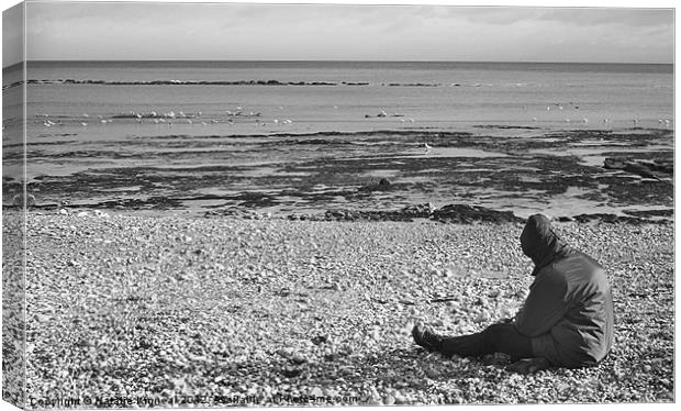 Lone Man Sitting on Pebble Beach Canvas Print by Natalie Kinnear