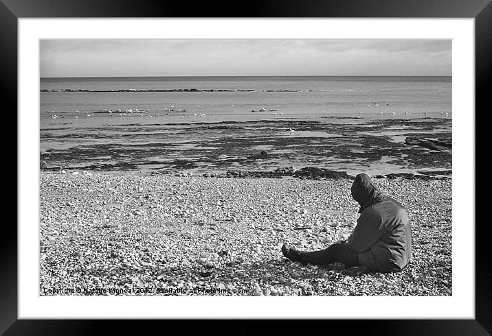 Lone Man Sitting on Pebble Beach Framed Mounted Print by Natalie Kinnear