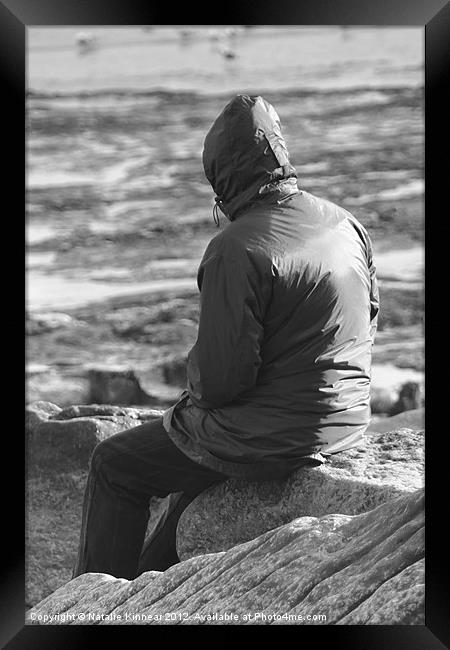 Lone Man Sitting on a Rocky Beach Framed Print by Natalie Kinnear