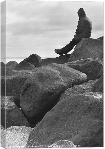 Lone Man Sitting on Rocky Beach Canvas Print by Natalie Kinnear