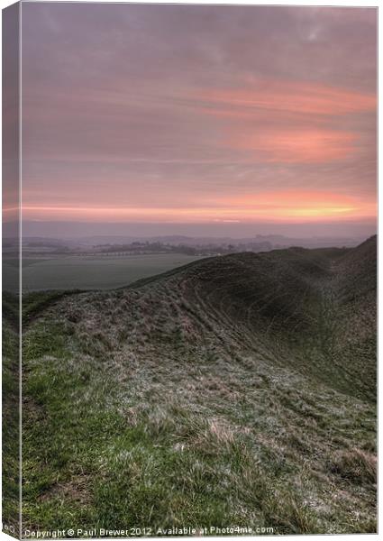 Sunrise over Maiden Castle Canvas Print by Paul Brewer