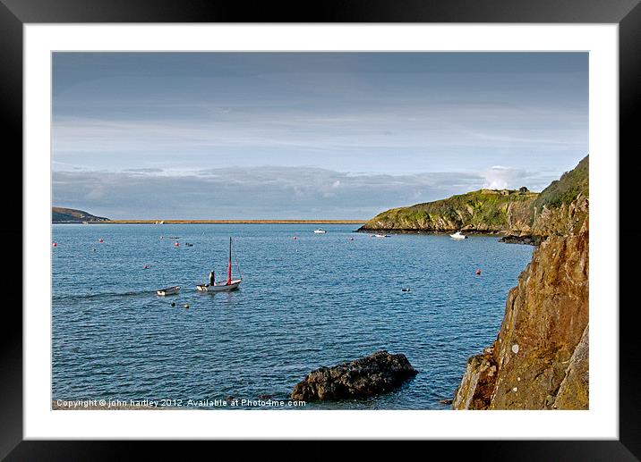 Sailing across Fishguard Harbour in a small boat Framed Mounted Print by john hartley