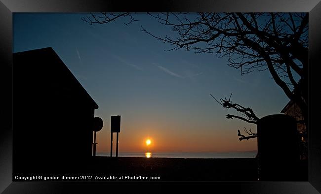 Sunrise and silhouettes at Calshot Framed Print by Gordon Dimmer