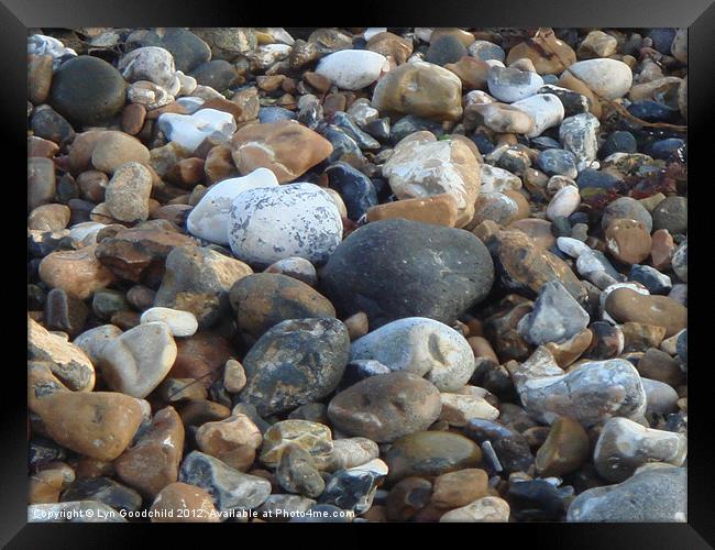 Pebbles on the shore Framed Print by Lyn Goodchild