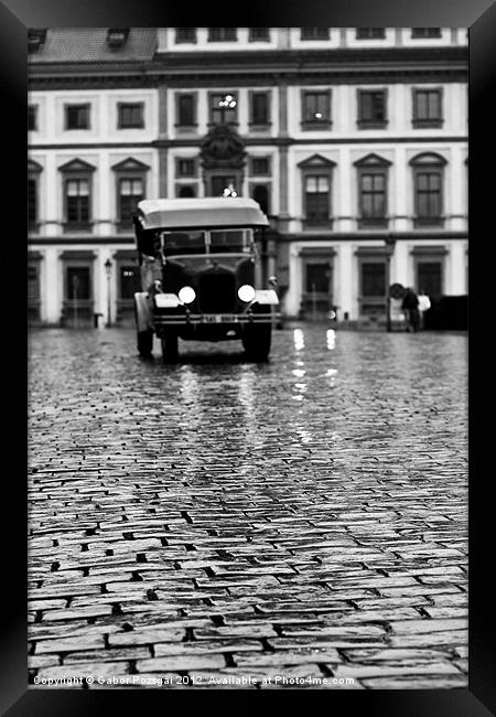 Old car approaching on cobblestone road Framed Print by Gabor Pozsgai