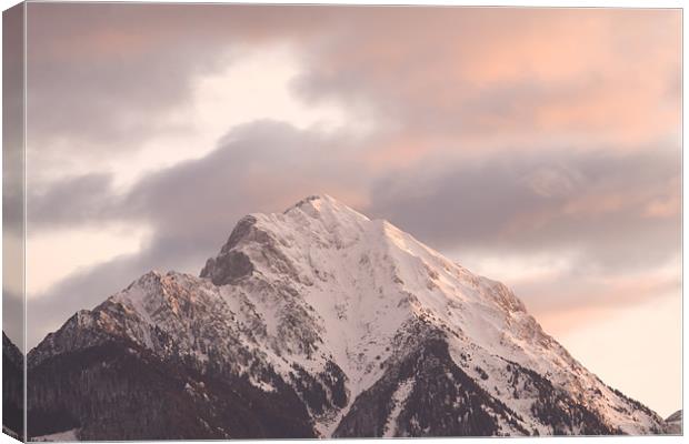 Mountain peak at sunrise Canvas Print by Ian Middleton