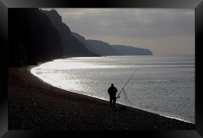 Fisherman angling on beach Framed Print by nick pautrat