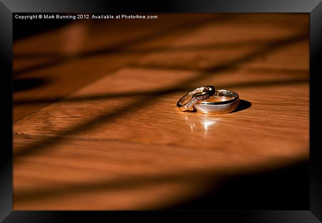 Wedding rings on a table Framed Print by Mark Bunning