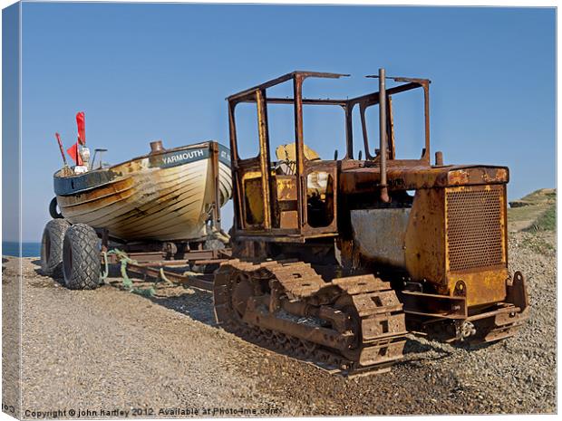 Rusty Caterpillar Beach Tractor with Fishing Boat  Canvas Print by john hartley
