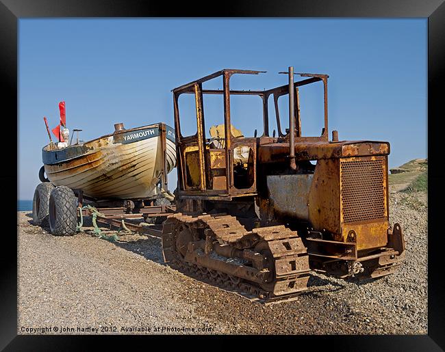 Rusty Caterpillar Beach Tractor with Fishing Boat  Framed Print by john hartley
