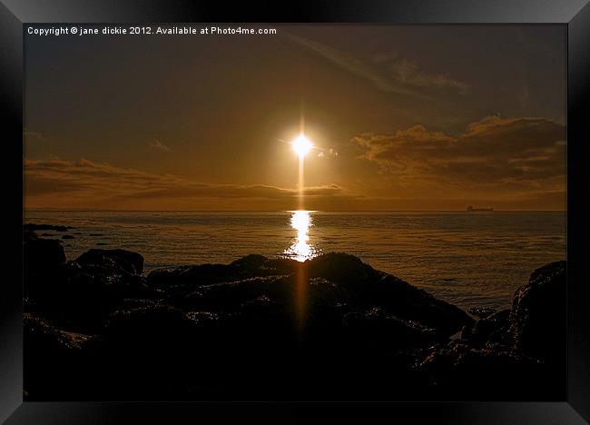 sunrise over rocks Framed Print by jane dickie