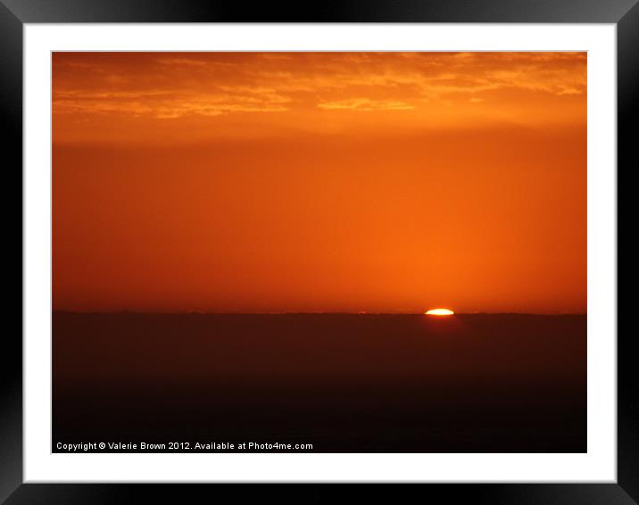 Sun disappearing under the horizon Framed Mounted Print by Valerie Brown