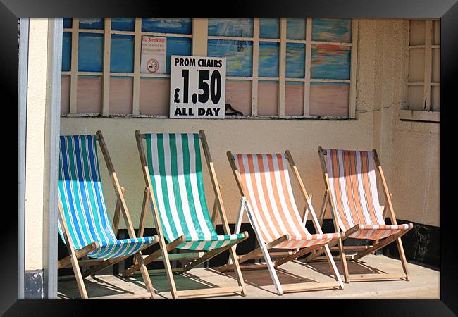 vacant deckchairs awaiting occupation Framed Print by dennis brown
