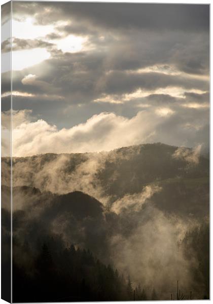 Storm clouds gather over mountains Canvas Print by Ian Middleton