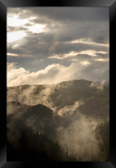 Storm clouds gather over mountains Framed Print by Ian Middleton