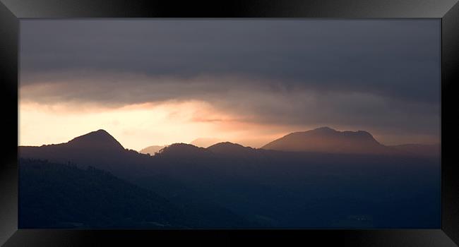 Mountain peak at sunrise Framed Print by Ian Middleton
