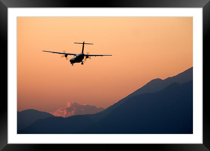 Airplane landing at sunset Framed Mounted Print by Ian Middleton
