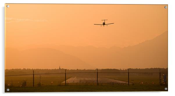 Light airplane landing at sunset Acrylic by Ian Middleton