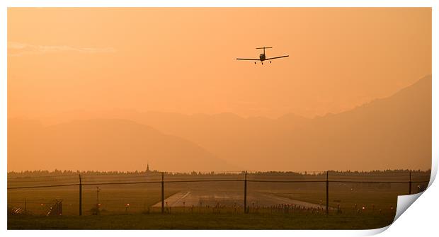 Light airplane landing at sunset Print by Ian Middleton