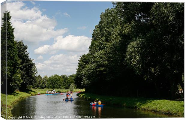 Fun on the river in a canoe Canvas Print by Mark Bunning