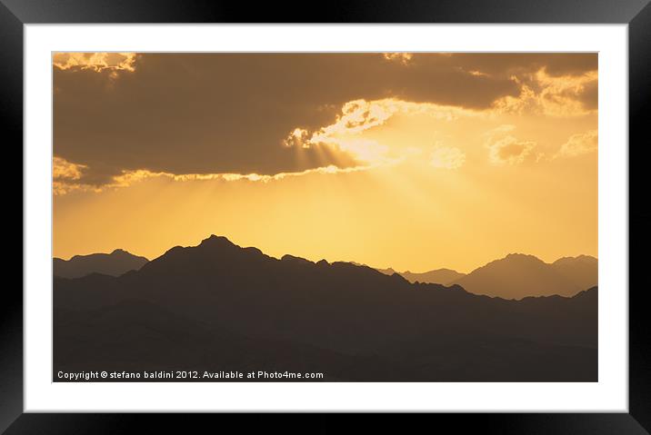 Sunlight through clouds at sunset over the Sinai d Framed Mounted Print by stefano baldini