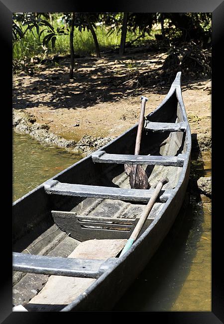 Angled canoe on sandy bank Framed Print by Arfabita  