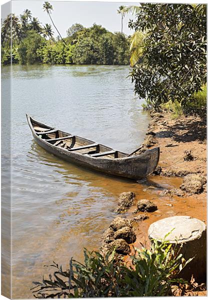 Canoe moored on sandy bank Canvas Print by Arfabita  