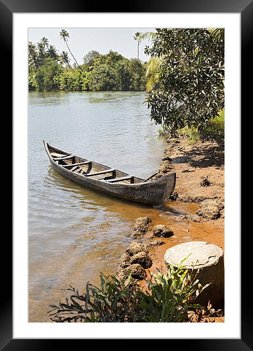 Canoe moored on sandy bank Framed Mounted Print by Arfabita  