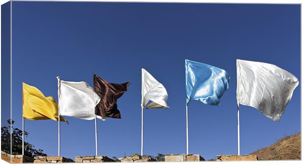 Flags fluttering against blue Sky Canvas Print by Arfabita  