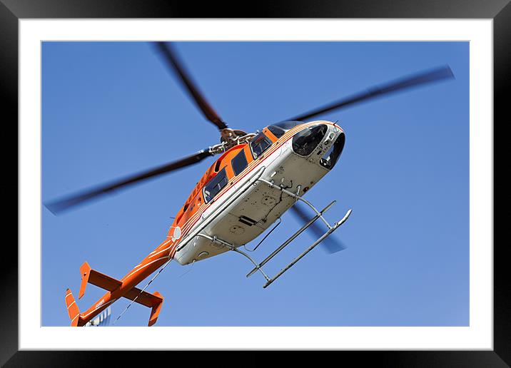 Hovering to land Orange White Helicopter Framed Mounted Print by Arfabita  