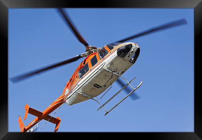 Hovering to land Orange White Helicopter Framed Print by Arfabita  