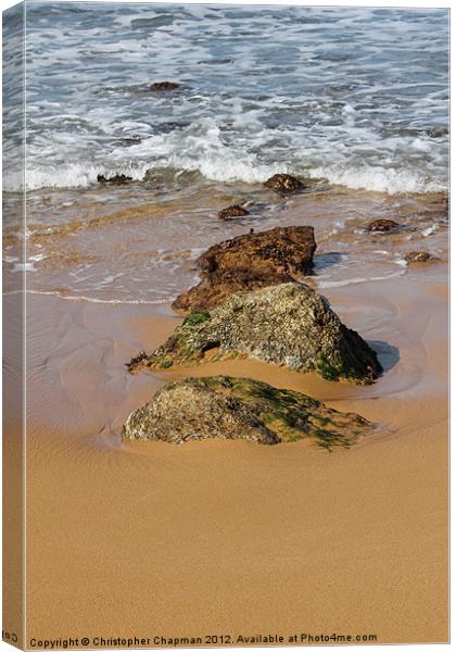 Rocks in the surf on Ramla Bay Canvas Print by Christopher Chapman