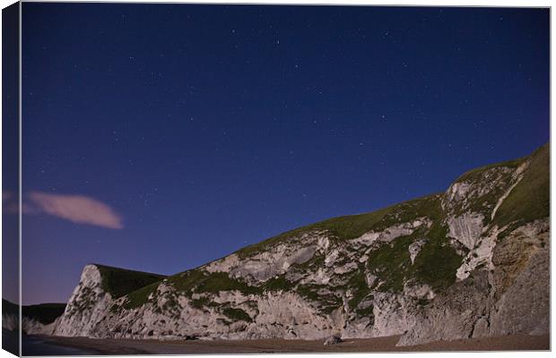 Starry night at Durdle Door Canvas Print by Ian Middleton