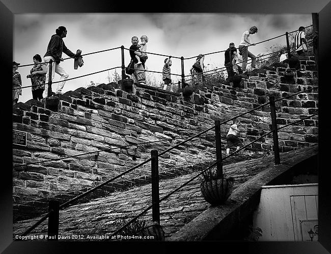 Climbing Whitby Abbey steps Framed Print by Paul Davis